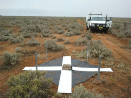 White MDF over black weedmat target placed over survey mark pillar