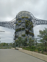 Greenery on concrete silos with arty hunks of metal linking them together